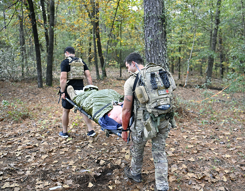 Students in the Special Forces Combat Medic Refresher Course at the U.S. Army John F. Kennedy Special Warfare Center and School carry a simulated patient during casualty training at Fort Bragg, North Carolina, Oct. 27, 2020.  (U.S. Army photo by K. Kassens)